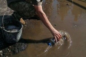 Перед візитом Зеленського до Луцька армійці вичерпували воду з калюж пляшками (Фото, відео)
