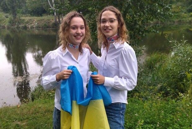 Близнючки з Сіверського Дінця показали прапор, який привезли з собою до Луцька 